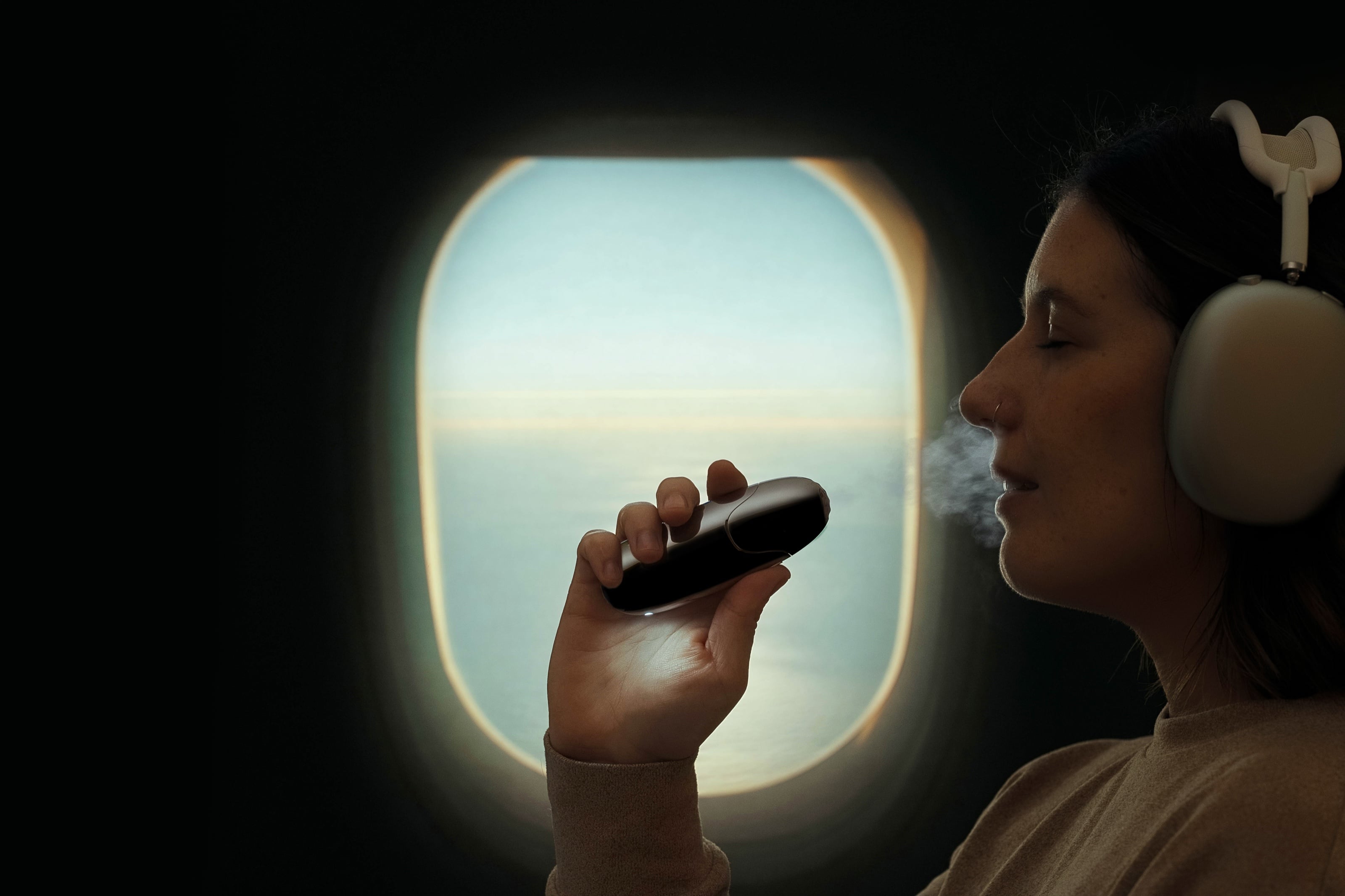 A traveller breathing halite by an airplane window